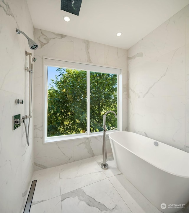 bathroom featuring a bathtub and a healthy amount of sunlight