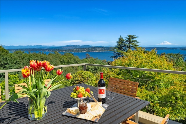 balcony featuring a water and mountain view