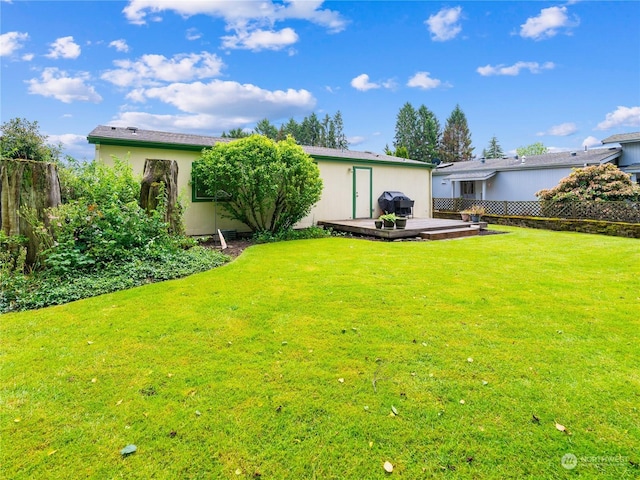 back of house featuring a deck and a lawn