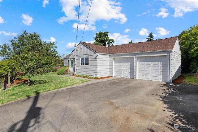 view of front of property with a garage and a front yard