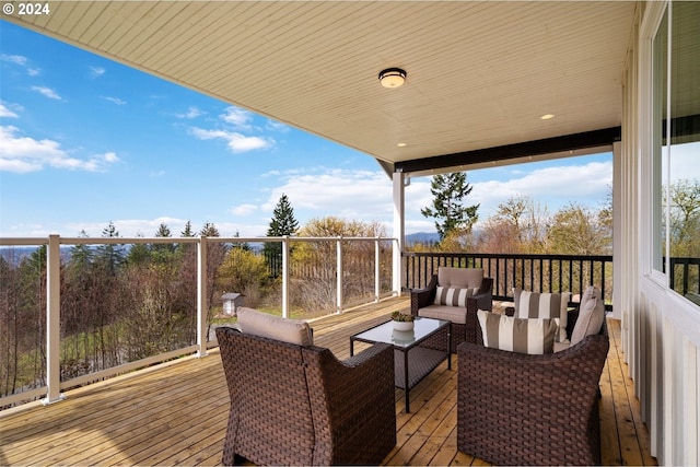 wooden terrace with an outdoor living space