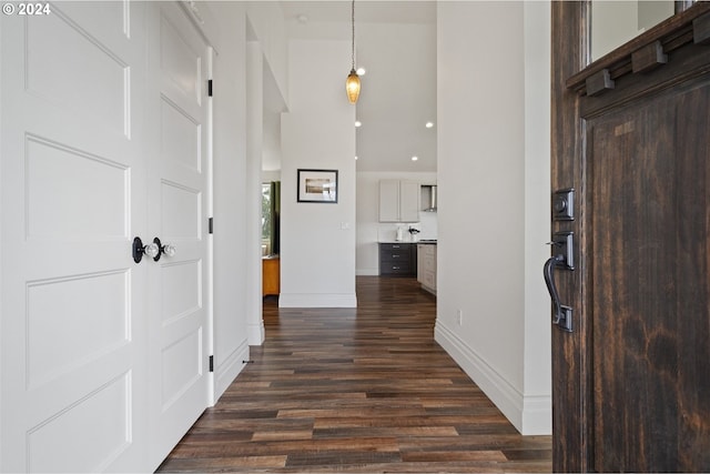 hallway with dark hardwood / wood-style floors