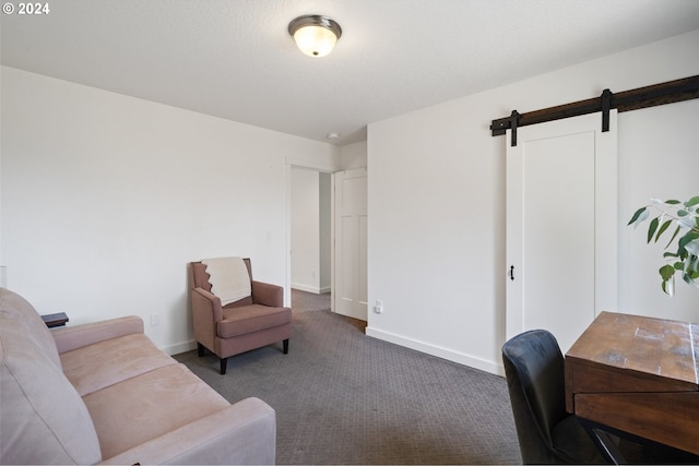 interior space featuring a barn door and dark colored carpet