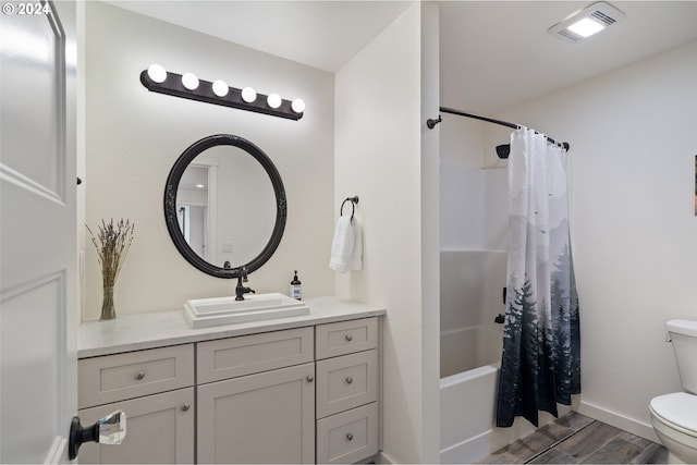 full bathroom with vanity, hardwood / wood-style floors, toilet, and shower / bath combo with shower curtain