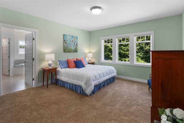 carpeted bedroom featuring ensuite bathroom