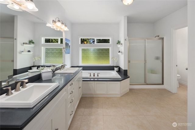 full bathroom with plus walk in shower, toilet, tile patterned floors, and dual bowl vanity