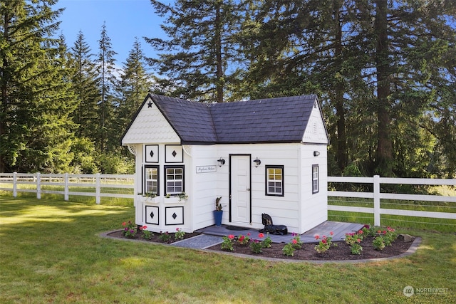 view of outbuilding featuring a lawn