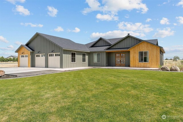 view of front of house with a garage and a front yard