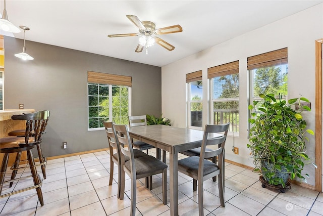 dining area featuring ceiling fan and light tile patterned floors