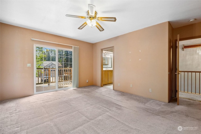 unfurnished room featuring ceiling fan and light carpet