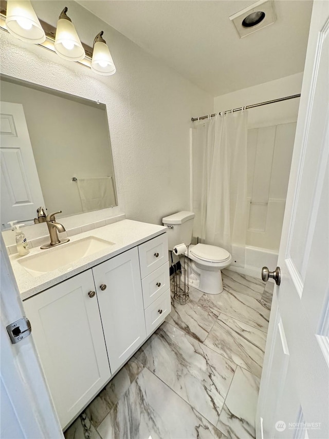 full bathroom with vanity, toilet, and shower / bath combo with shower curtain