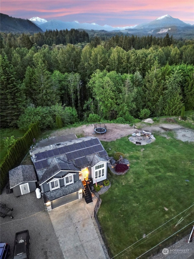 aerial view at dusk featuring a mountain view