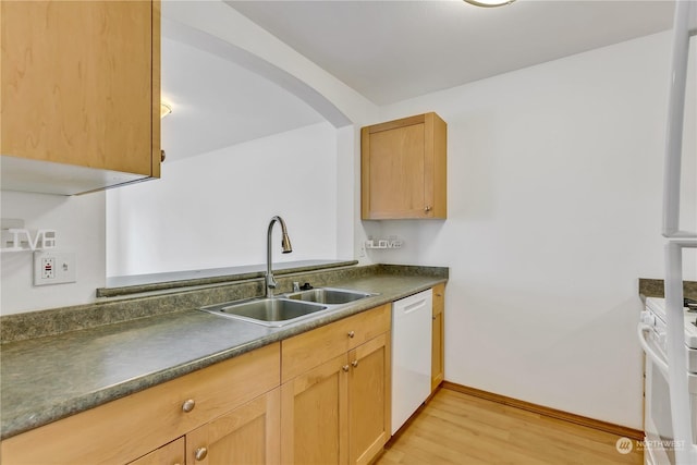 kitchen with light hardwood / wood-style floors, white appliances, sink, and light brown cabinetry