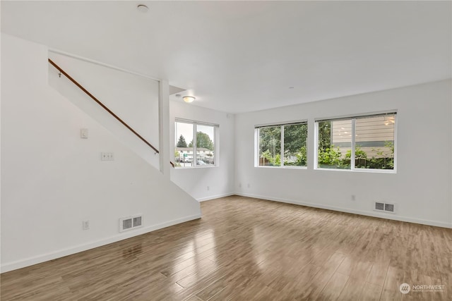 empty room with hardwood / wood-style flooring