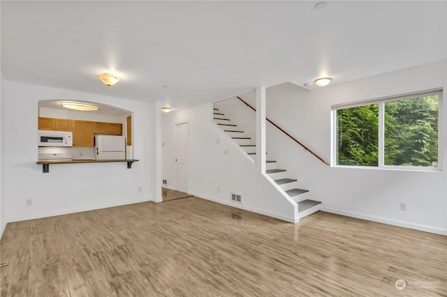 unfurnished living room featuring light hardwood / wood-style floors