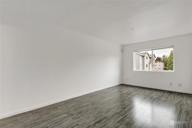 unfurnished room featuring dark hardwood / wood-style floors