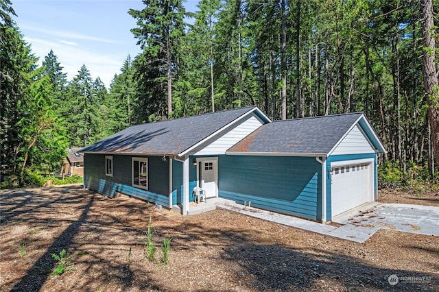 ranch-style house featuring a garage and covered porch