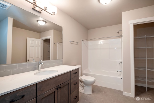 full bathroom featuring tasteful backsplash, toilet, tile floors, shower / bathtub combination, and vanity