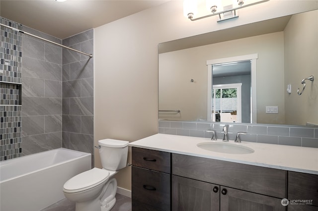 full bathroom with vanity with extensive cabinet space, backsplash, toilet, and tiled shower / bath combo