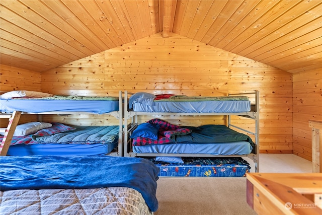 carpeted bedroom featuring lofted ceiling with beams and wood ceiling