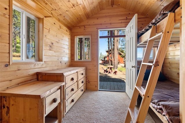 interior space with multiple windows, wooden ceiling, light carpet, and lofted ceiling