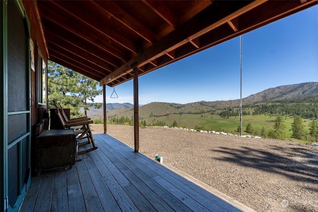 wooden deck with a mountain view and a rural view