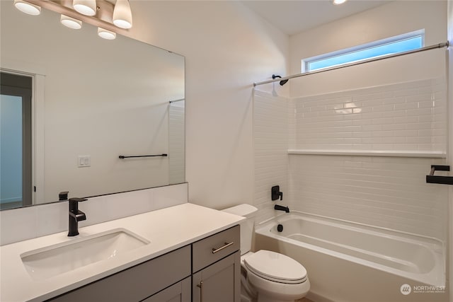 full bathroom with toilet, vanity, and tiled shower / bath