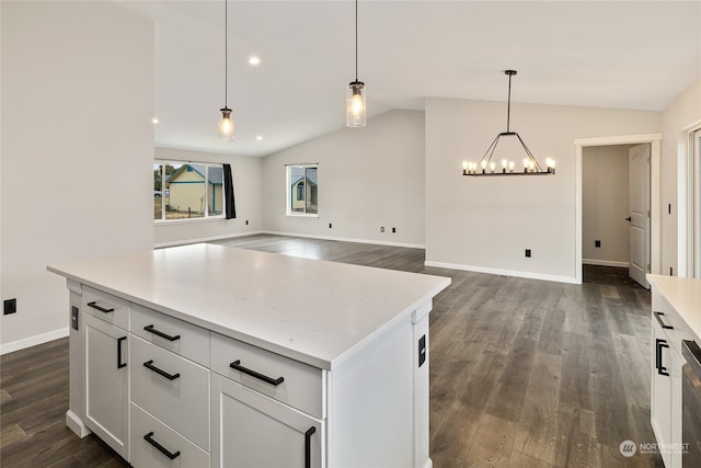 kitchen with lofted ceiling, hanging light fixtures, and dark hardwood / wood-style flooring