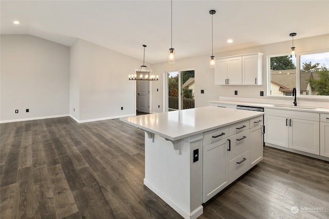 kitchen featuring a kitchen island, a wealth of natural light, white cabinetry, and decorative light fixtures