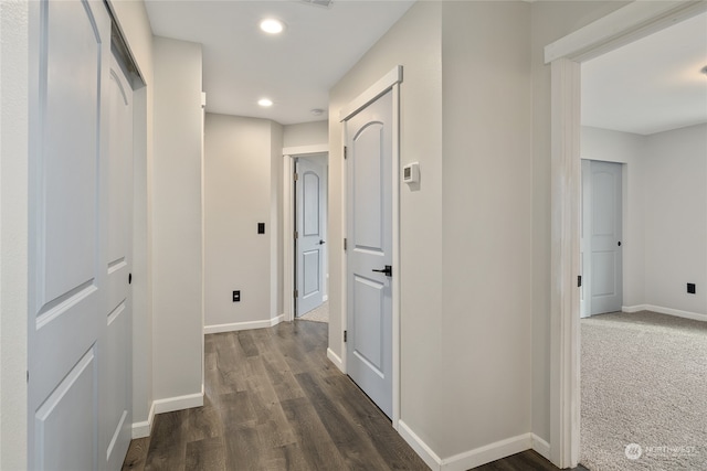 hallway with dark hardwood / wood-style floors