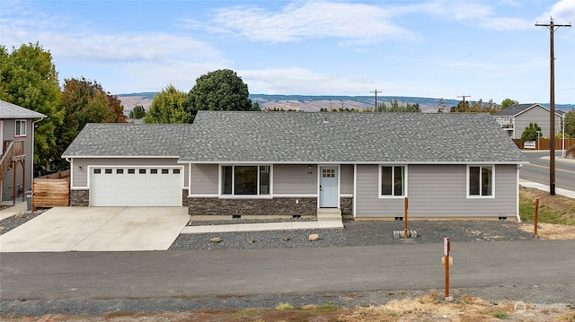 ranch-style house featuring a garage and a mountain view