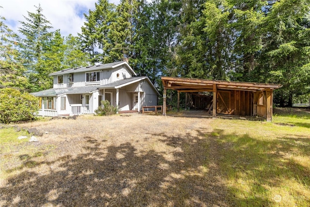 view of front of house with covered porch and a front yard