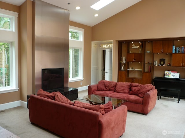 carpeted living room featuring a wealth of natural light and high vaulted ceiling