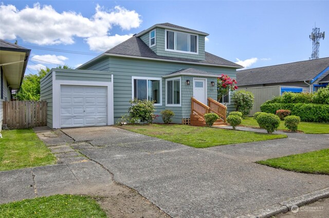 view of front of property with a front lawn and a garage