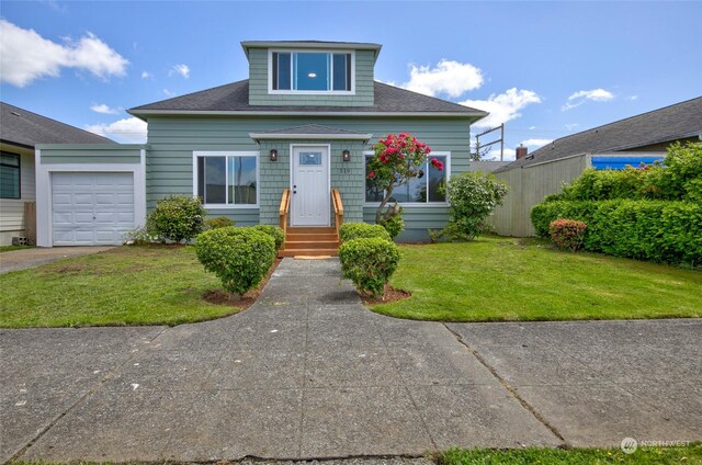 view of front of home featuring a garage and a front yard