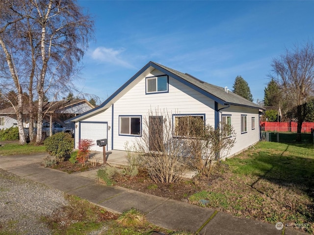 view of home's exterior featuring a lawn and a garage