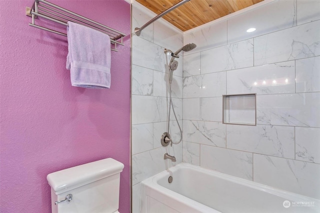 bathroom featuring toilet, wooden ceiling, and tiled shower / bath