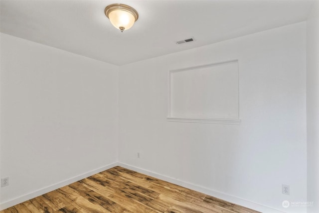 unfurnished room featuring hardwood / wood-style floors