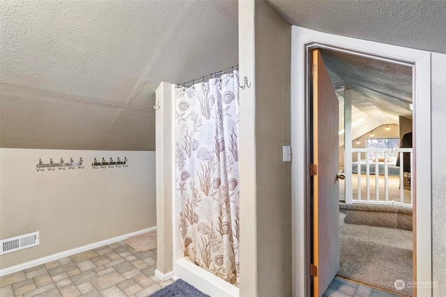 bathroom with lofted ceiling