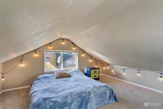 bedroom with carpet flooring, lofted ceiling, and a textured ceiling