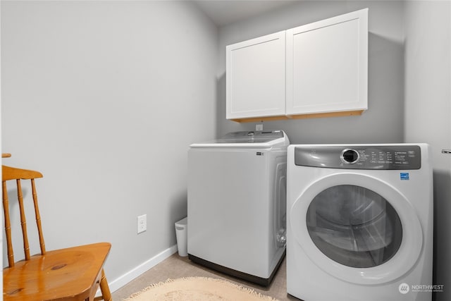 washroom with cabinets and separate washer and dryer