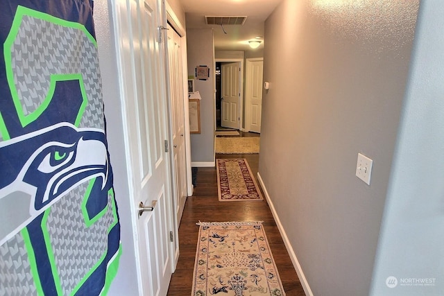 hall with dark hardwood / wood-style floors