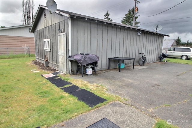 view of outdoor structure featuring a lawn