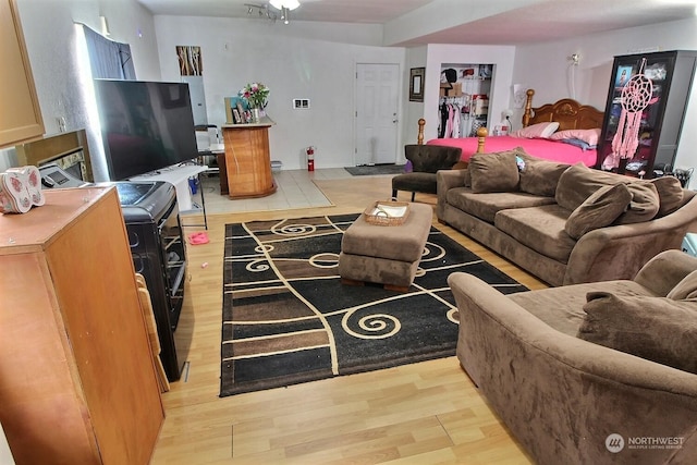 living room featuring ceiling fan and light hardwood / wood-style flooring