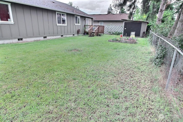 view of yard featuring a shed and a deck