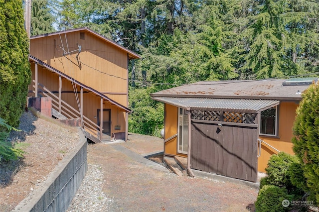 view of side of home with an outdoor structure