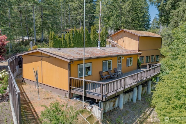 back of property featuring a wooden deck