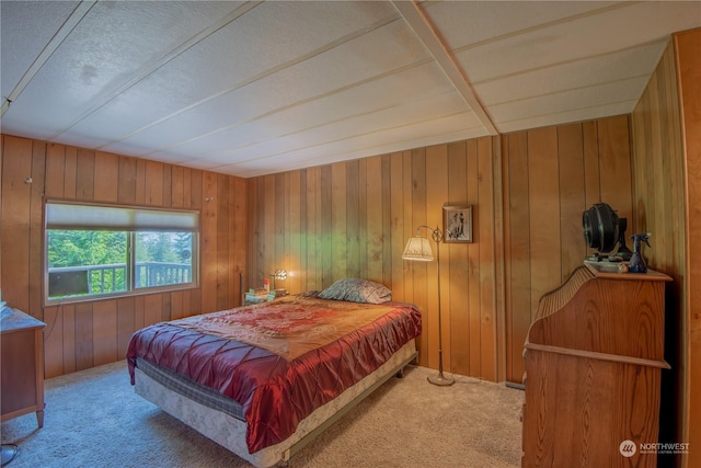 bedroom featuring carpet flooring and wooden walls