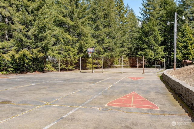 view of basketball court featuring tennis court