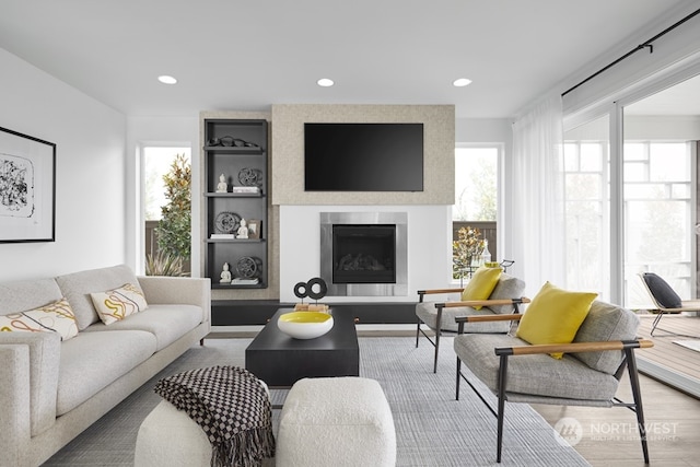 living room featuring hardwood / wood-style floors and a large fireplace